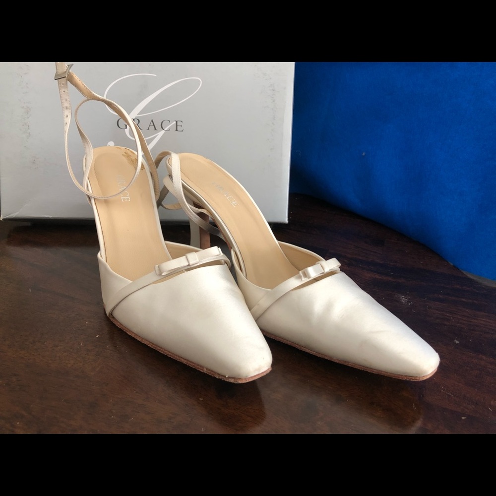 Grace white/ivory pointed ankle strap shoes.